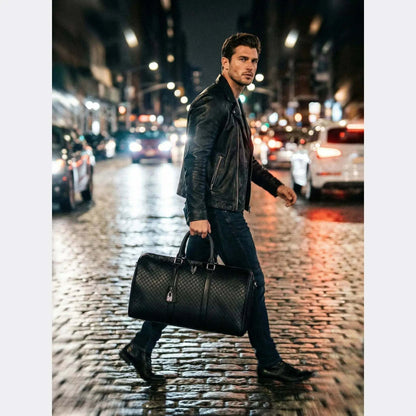 Man walking on a city street at night with a black leather bag