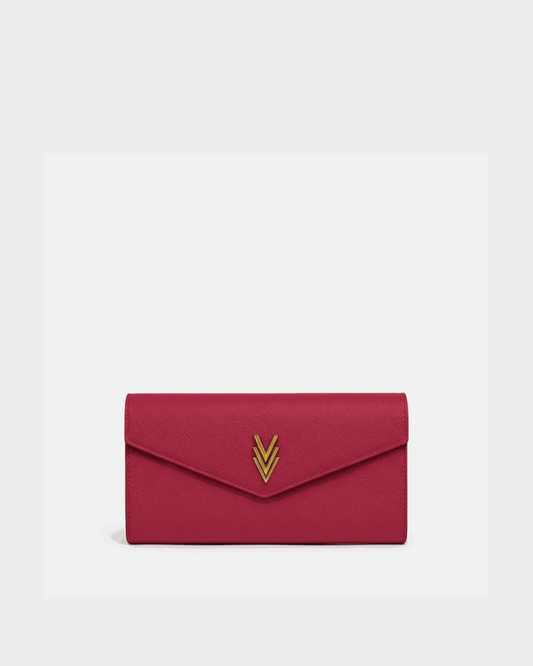 Red clutch bag with a gold emblem on a white background