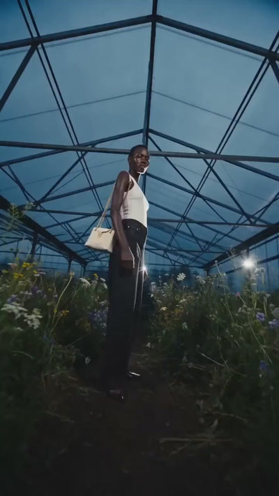 Model in garden wearing tilly purse