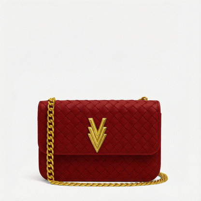 Red quilted handbag with gold chain and logo on a white background