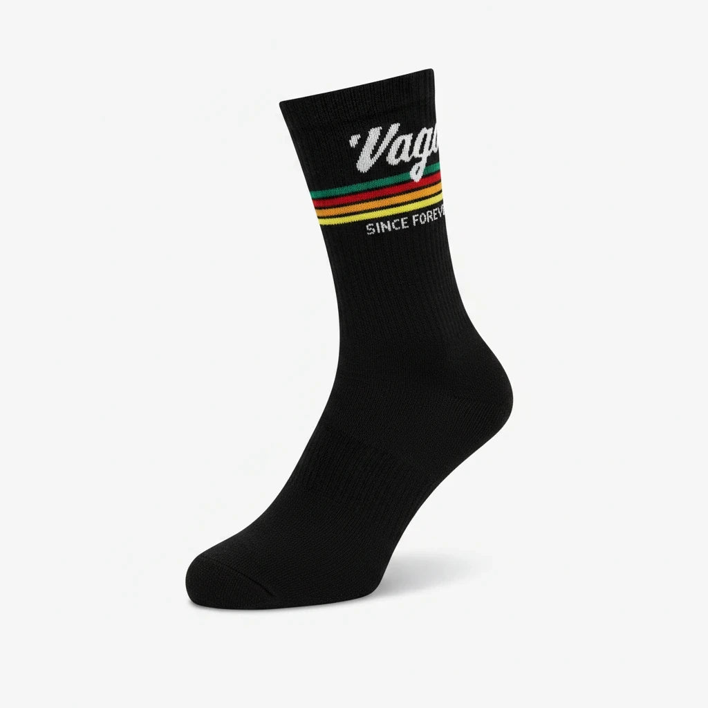 VAGOSHOPS black crew socks with vintage-inspired red, yellow, and green stripes and white Vago logo branding.