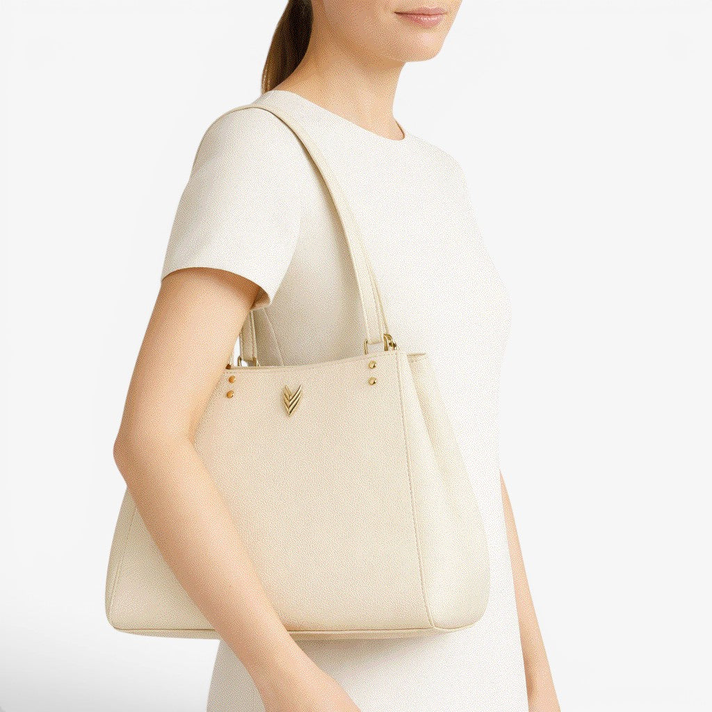 VAGOSHOPS Mari cream pebble-embossed vegan leather shoulder purse with dual straps and central zippered compartment.