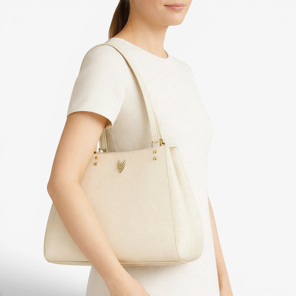 VAGOSHOPS Mari cream pebble-embossed vegan leather shoulder purse with dual straps and central zippered compartment.